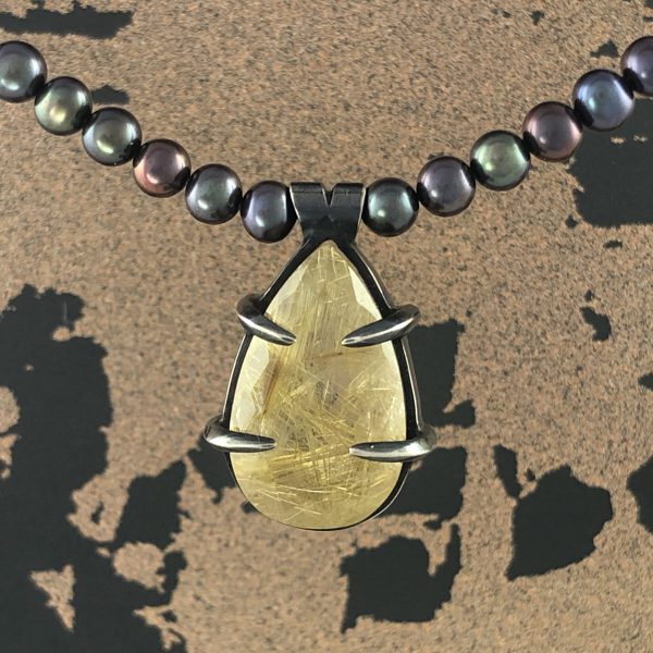 geo rutilated quartz claw pendant front